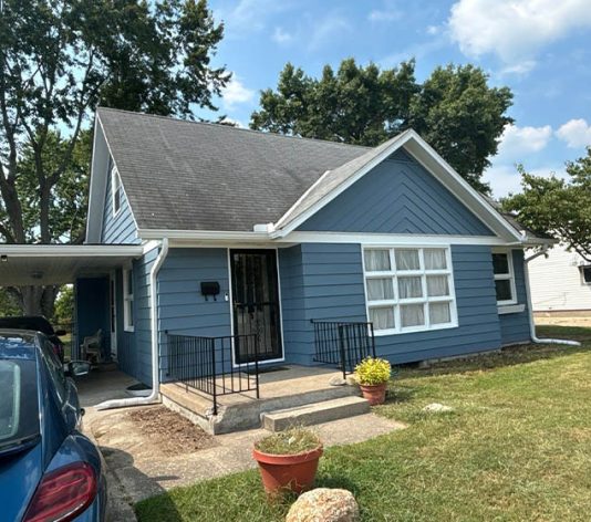 front view of residential house freshly painted blue