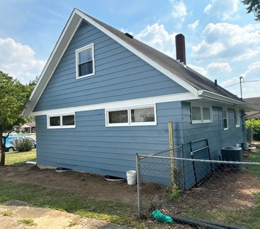 left side view of residential house freshly painted blue