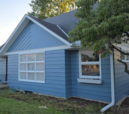 side view of residential house freshly painted blue