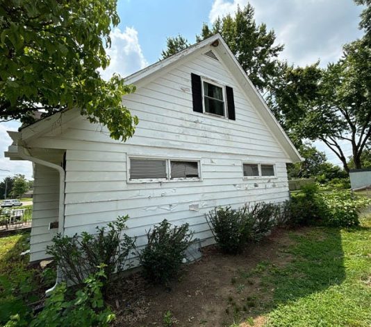 side view of residential house before new paint