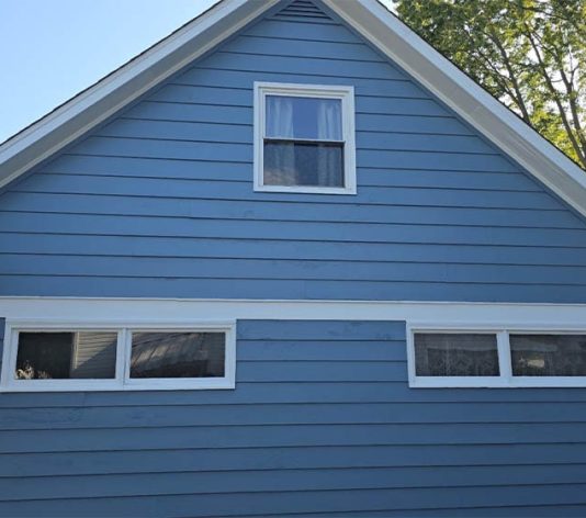 close-up side view of residential house freshly painted blue