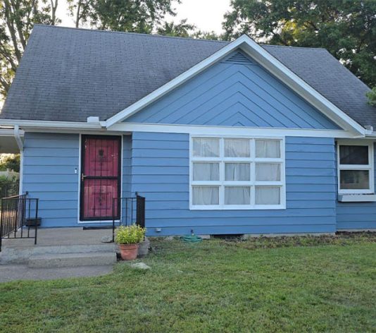 close-up front view of residential house freshly painted blue