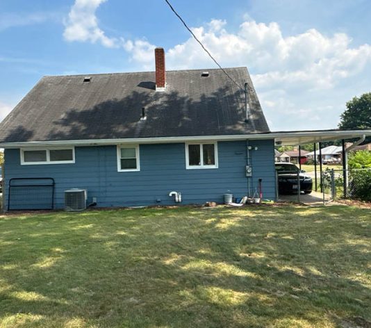 back view of residential house freshly painted blue