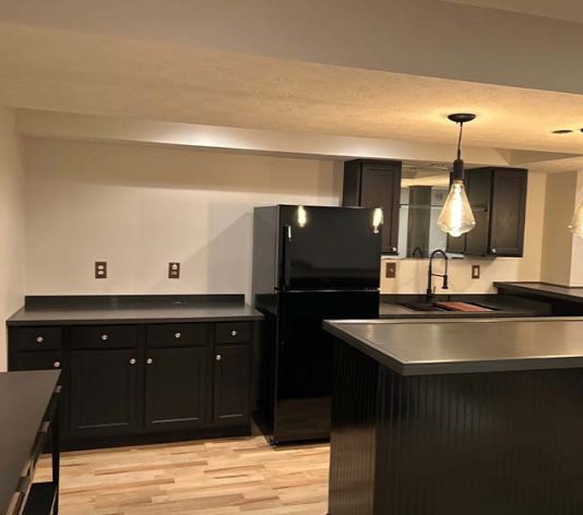 interior view of homeowner basement of freshly painted cabinets