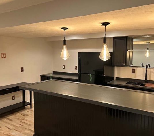 basement bar area with freshly painted cabinets for homeowner