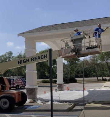 two painters painting a commercial building