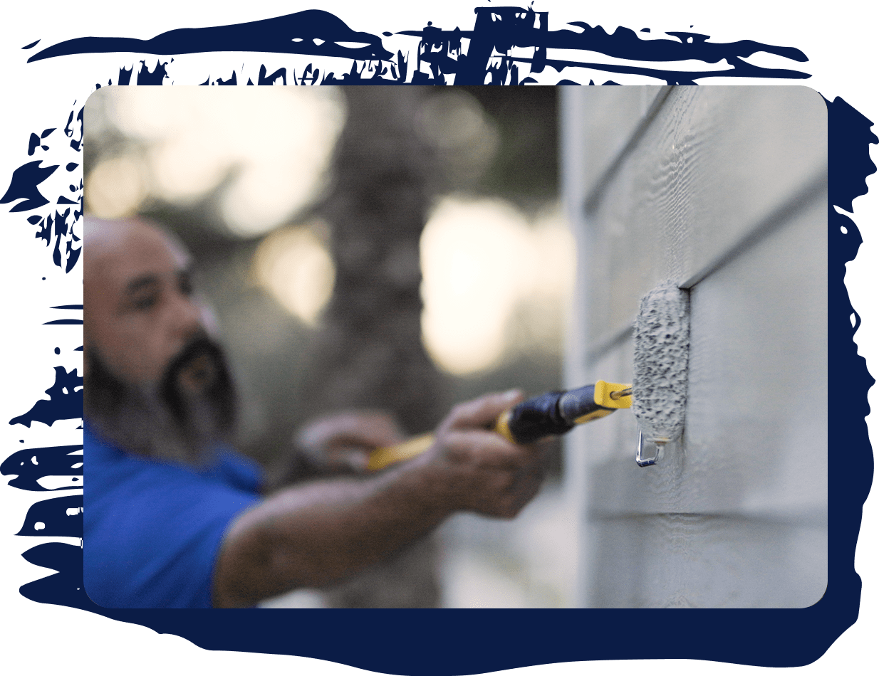 exterior painting contractor painting the side of the house